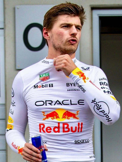 Person wearing a white racing suit with Red Bull and Oracle logos.
