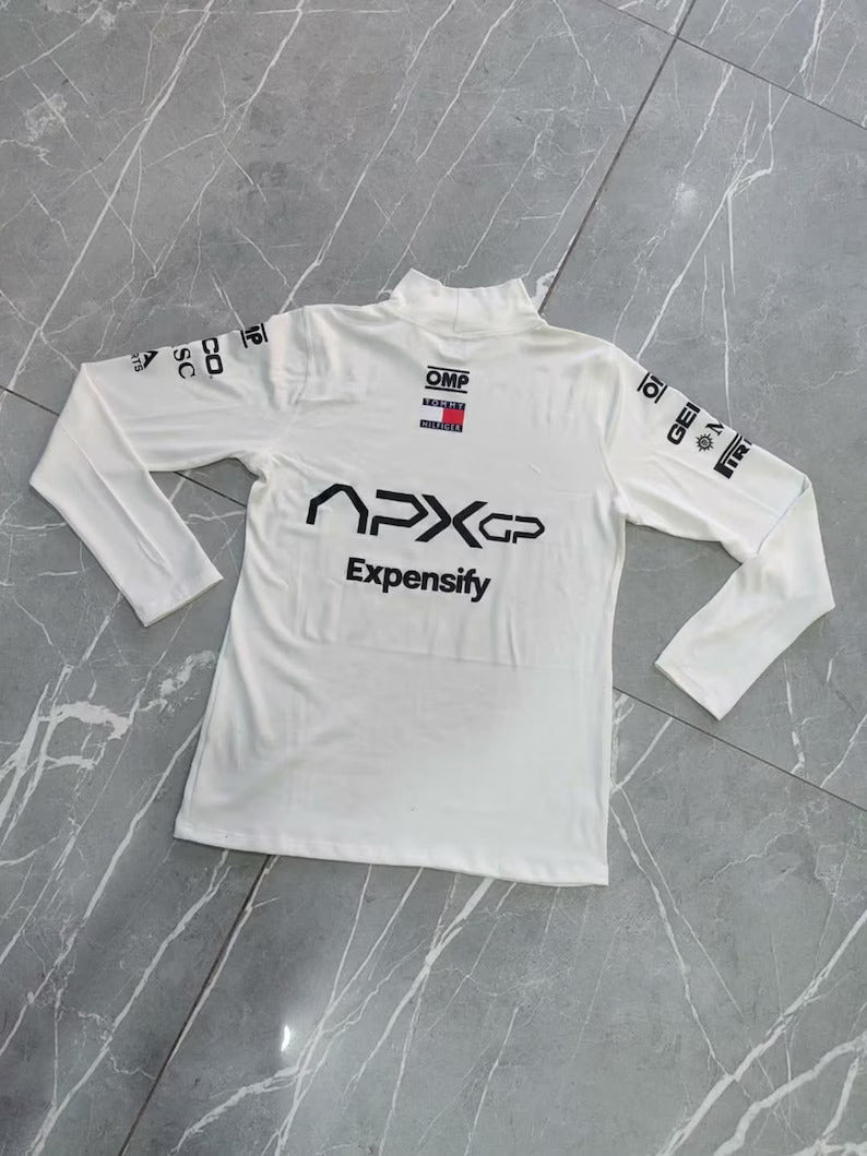 White long-sleeve shirt with branding on a gray surface