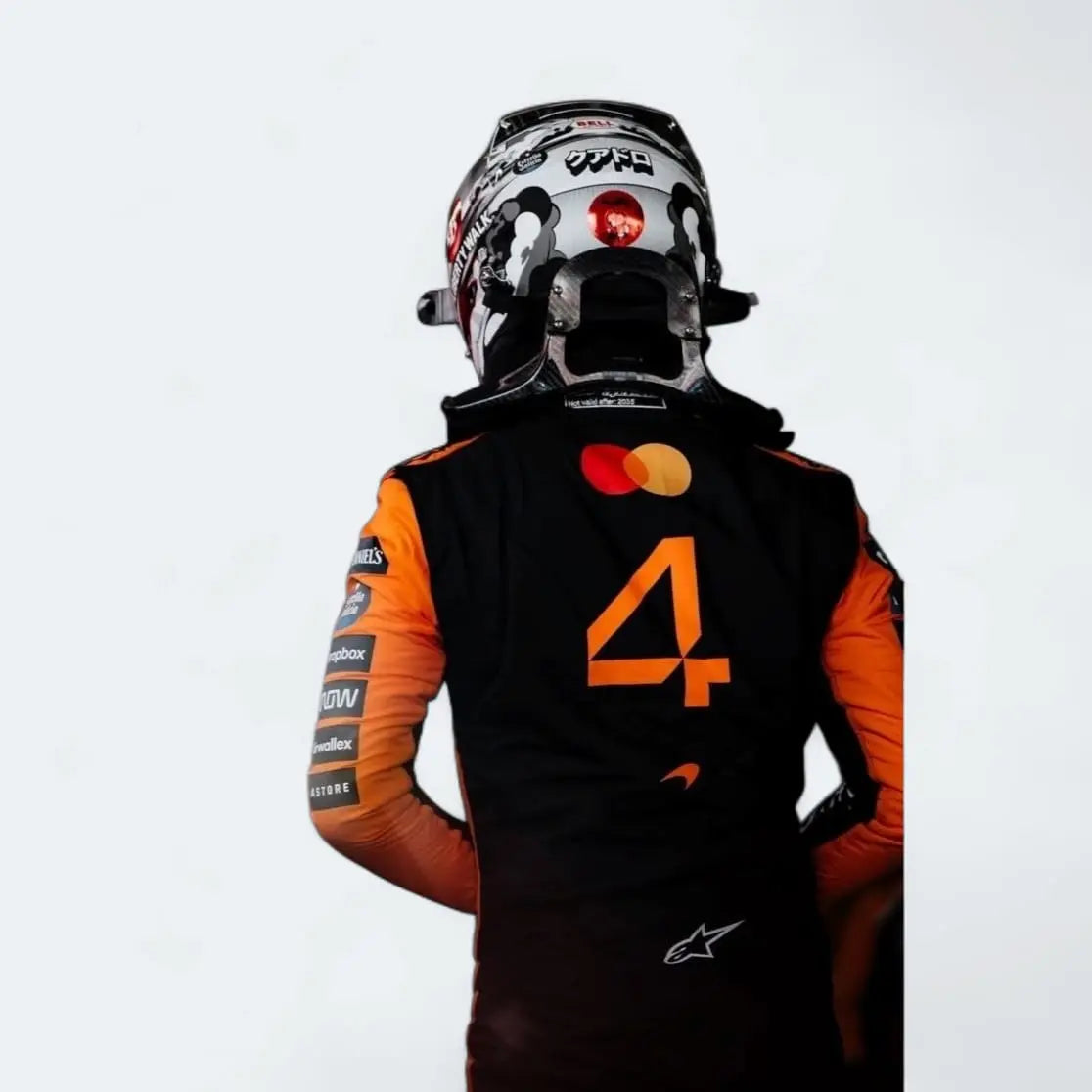 Lando Norris wearing a racing suit with orange and black design on a white background