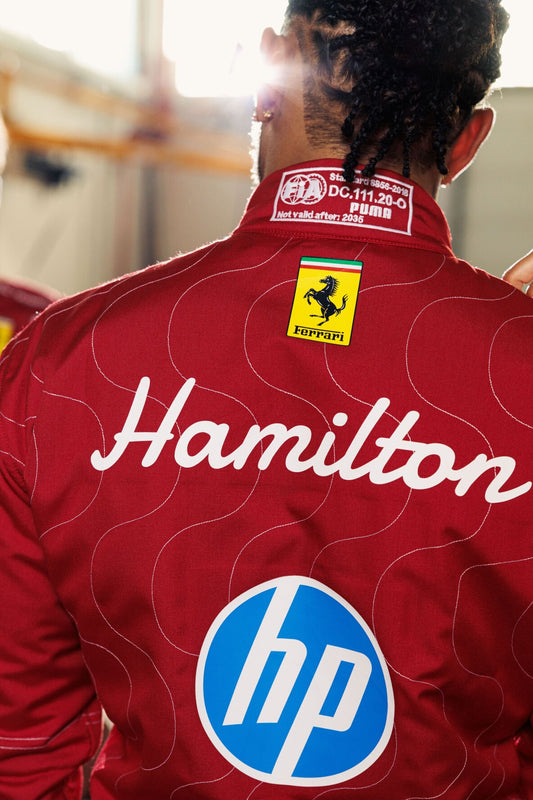 Red racing suit with 'Hamilton' and 'hp' logos, featuring a Ferrari emblem on the back.