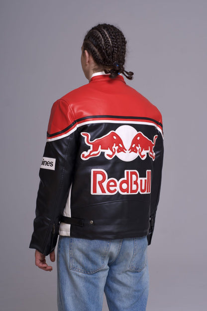 Person wearing a red and black leather jacket with Red Bull logo on a gray background
