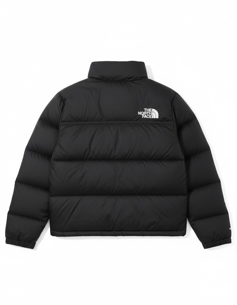 Black puffer jacket with The North Face logo on a white background