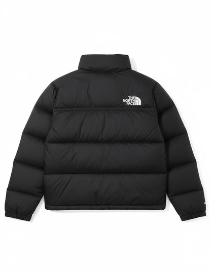 Black puffer jacket with The North Face logo on a white background