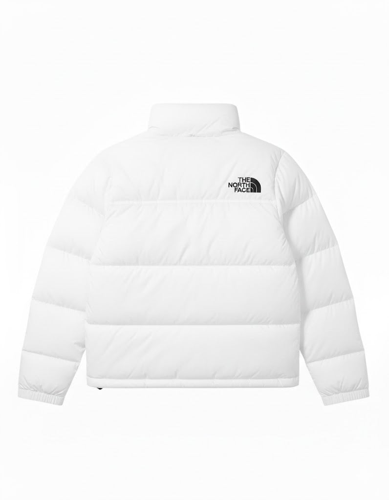 White puffer jacket with The North Face logo on a white background