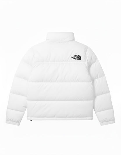 White puffer jacket with The North Face logo on a white background