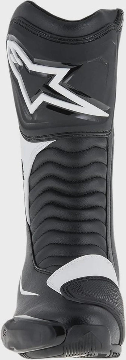 Black and white motorcycle boot with visible branding on a black background