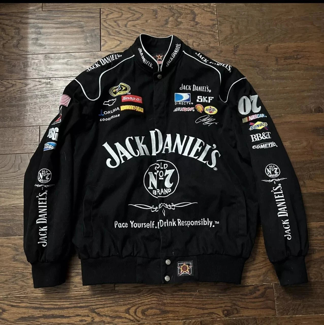 Black jacket with Jack Daniel's branding on a wooden surface