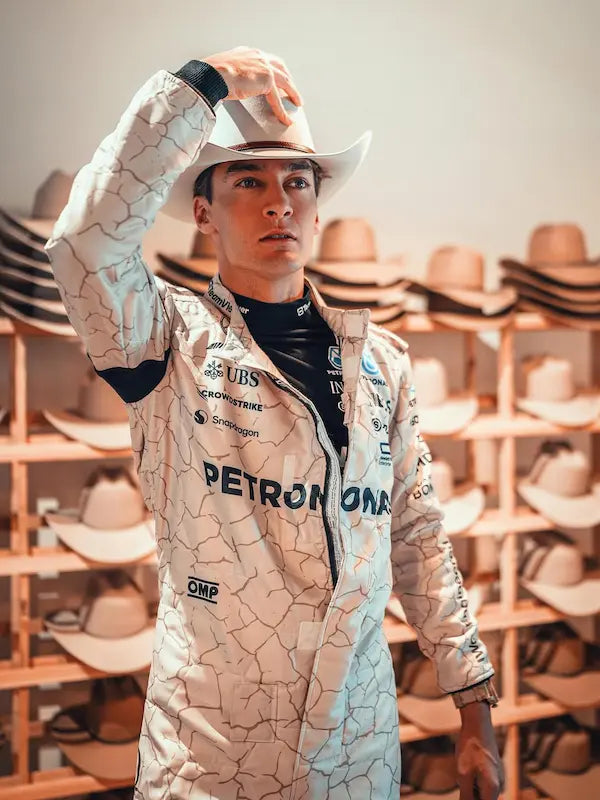 Person wearing a racing suit with sponsor logos in a hat store.