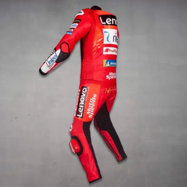 Red motorcycle racing suit with various brand logos on a gray background