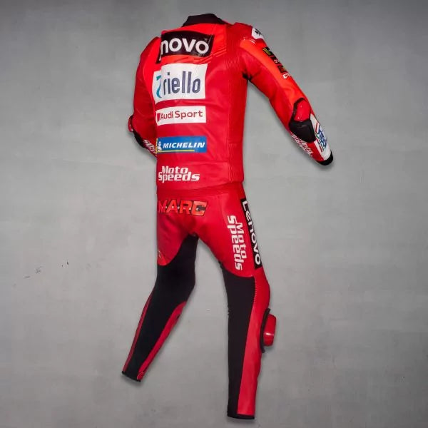 Red motorcycle racing suit with various brand logos on a gray background