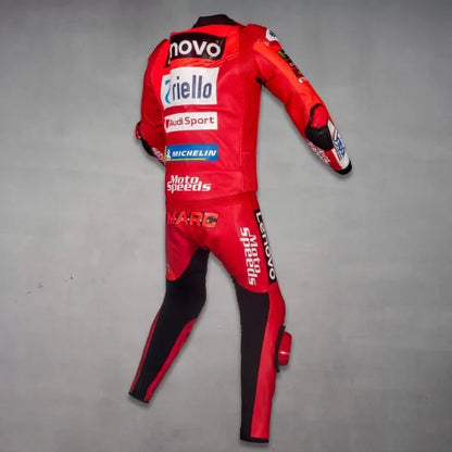Red motorcycle racing suit with various brand logos on a gray background